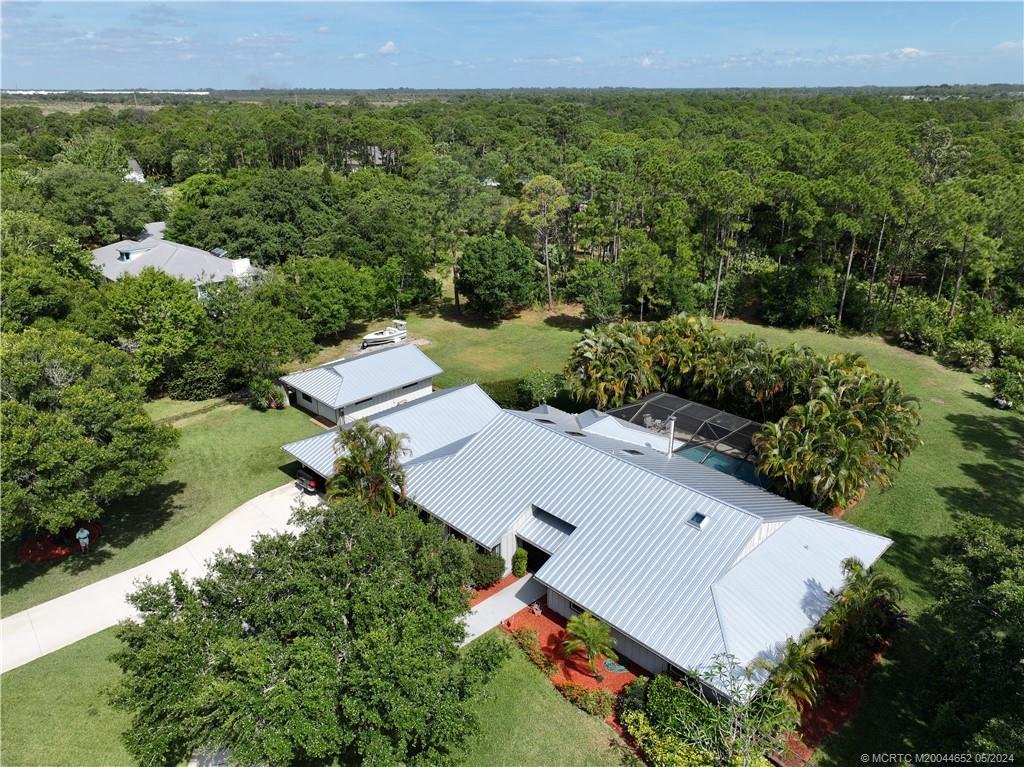 an aerial view of house with yard and mountain view in back