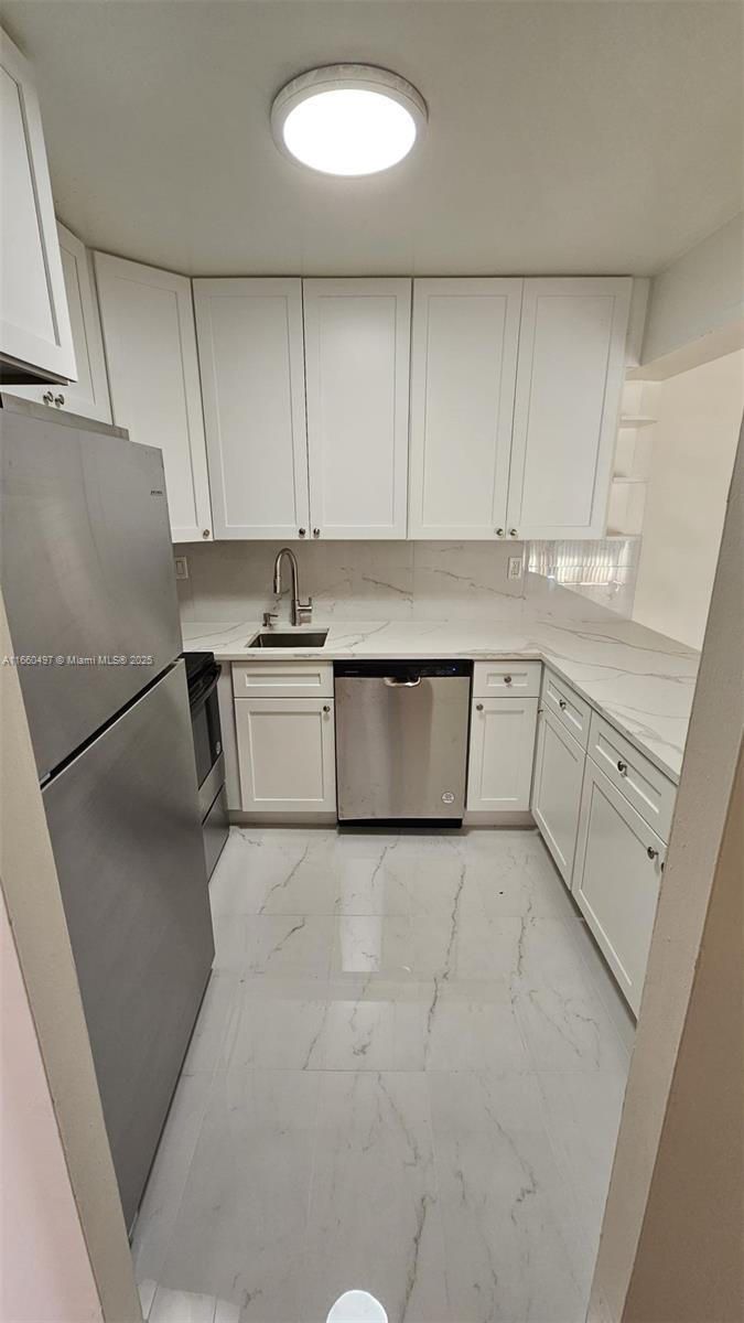 a kitchen with a stove and white cabinets