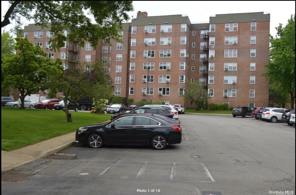 a couple of cars parked in front of a building