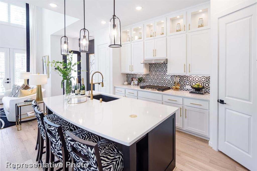 a kitchen with kitchen island a sink table and chairs