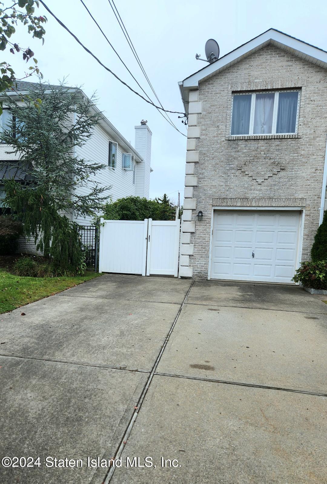 a view of a house with a yard and garage