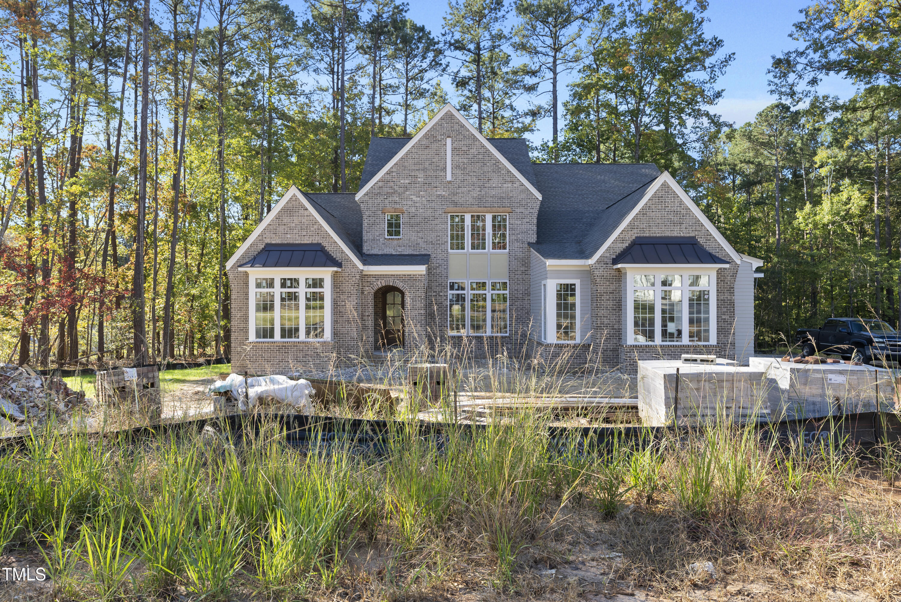 a front view of house with yard and lake view