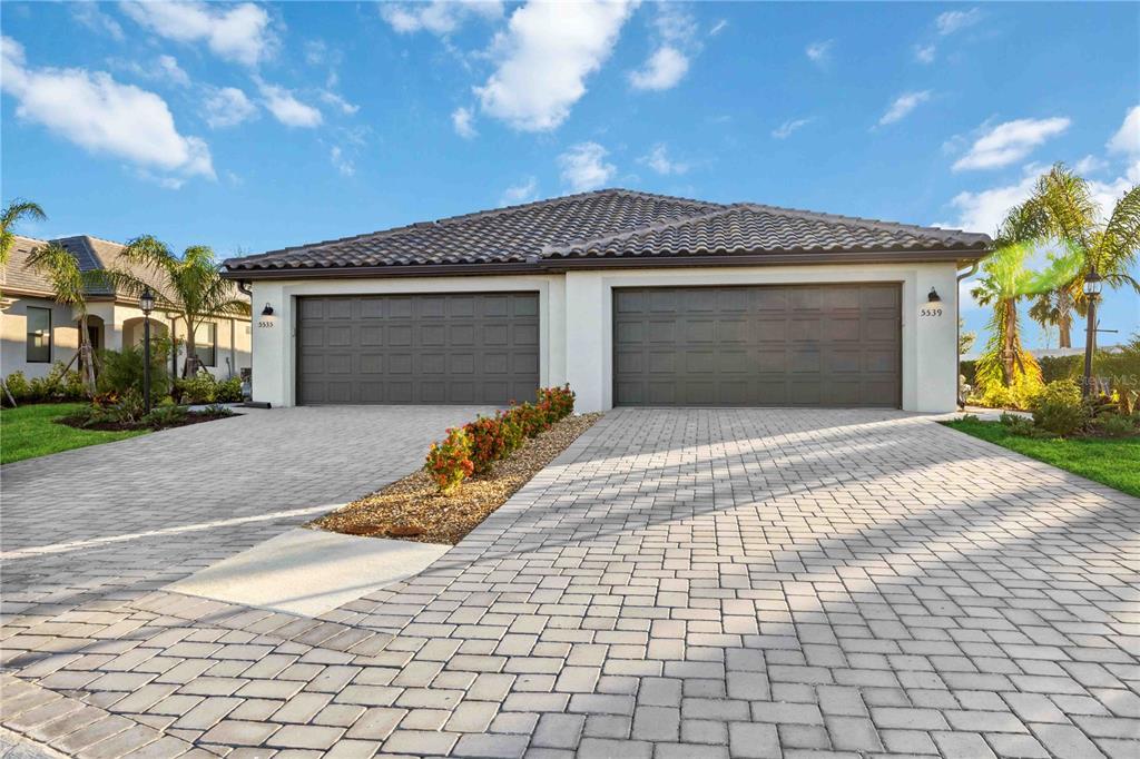 a front view of a house with a yard and garage