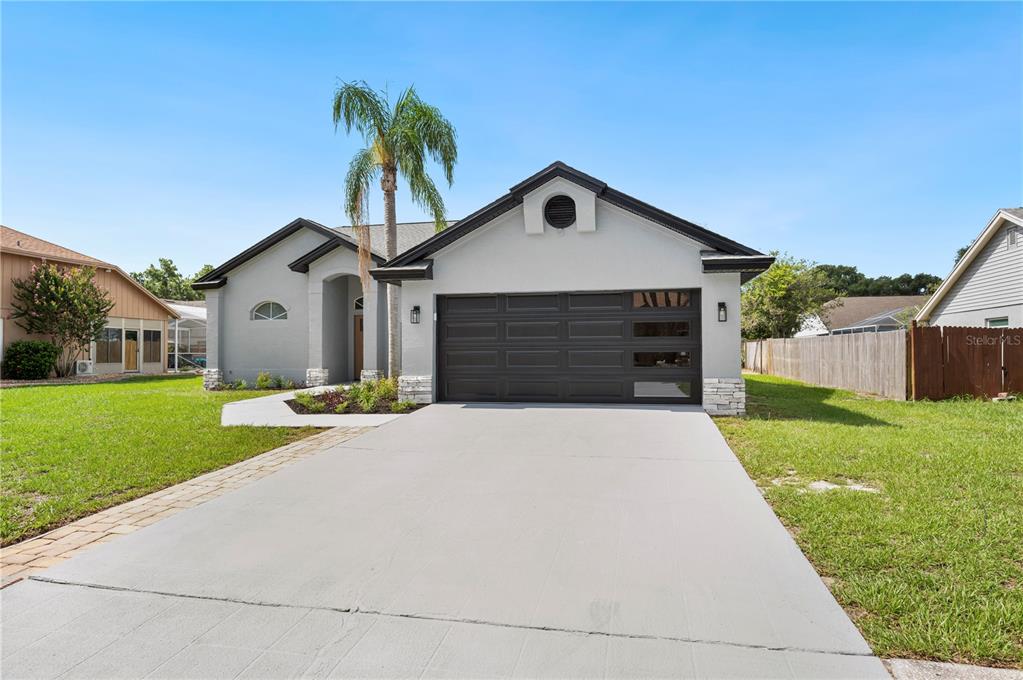 a front view of a house with a yard and garage