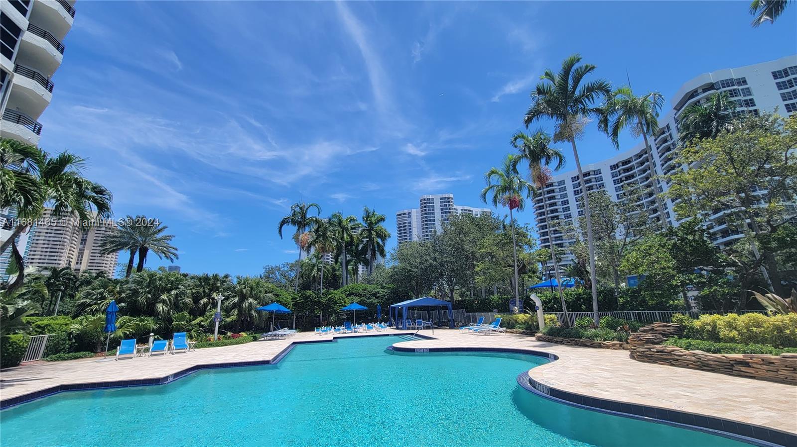 a view of a swimming pool and lounge chairs