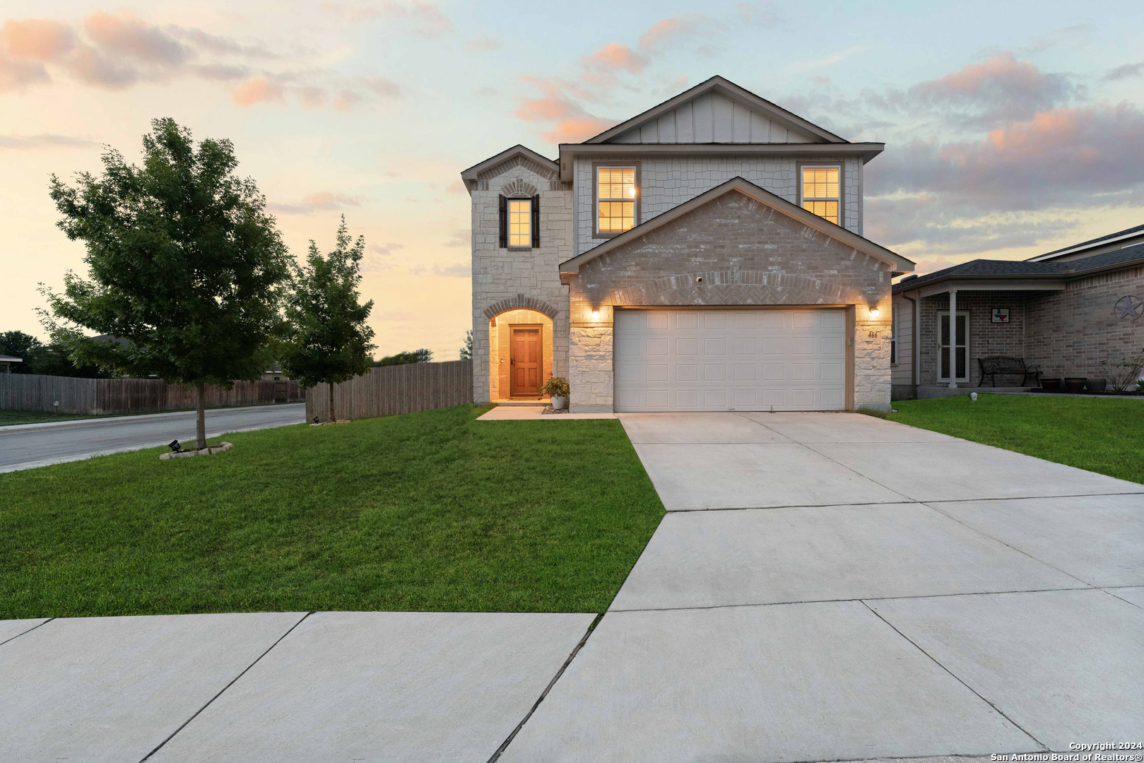 a front view of house with yard and green space