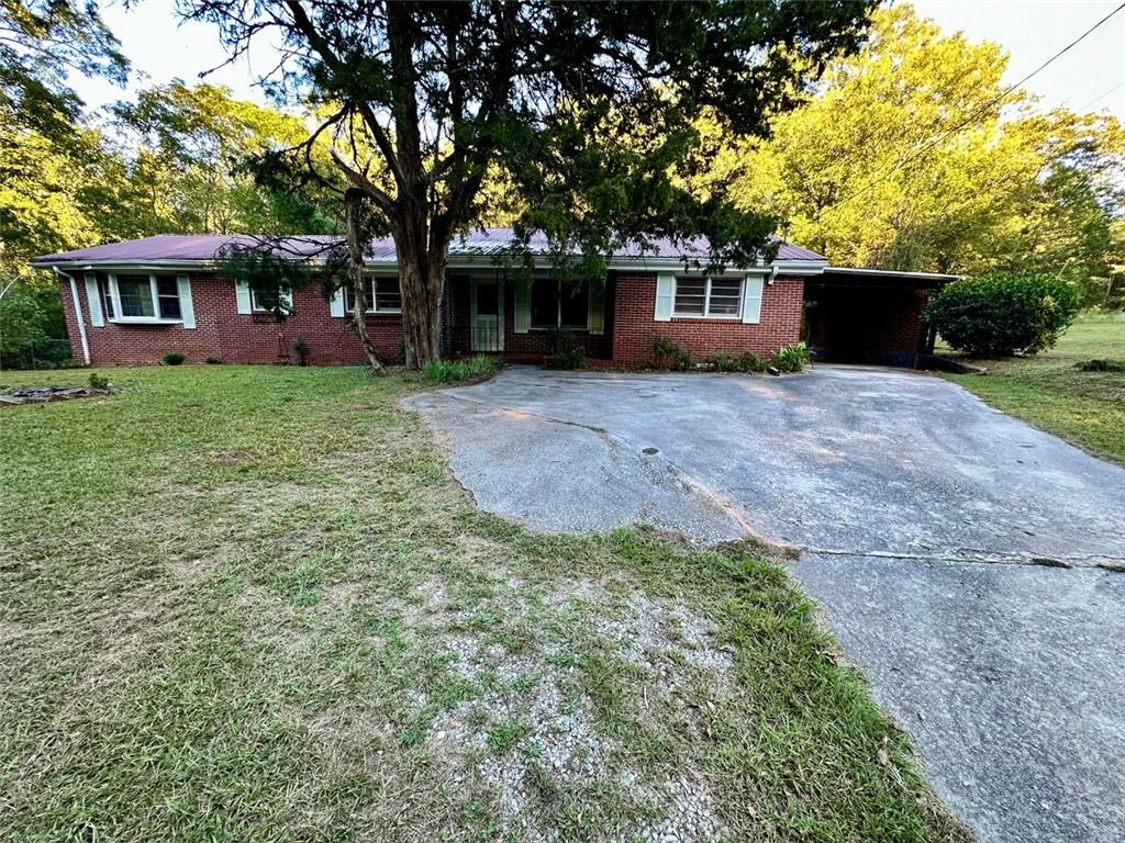 front view of a house with a yard and an trees