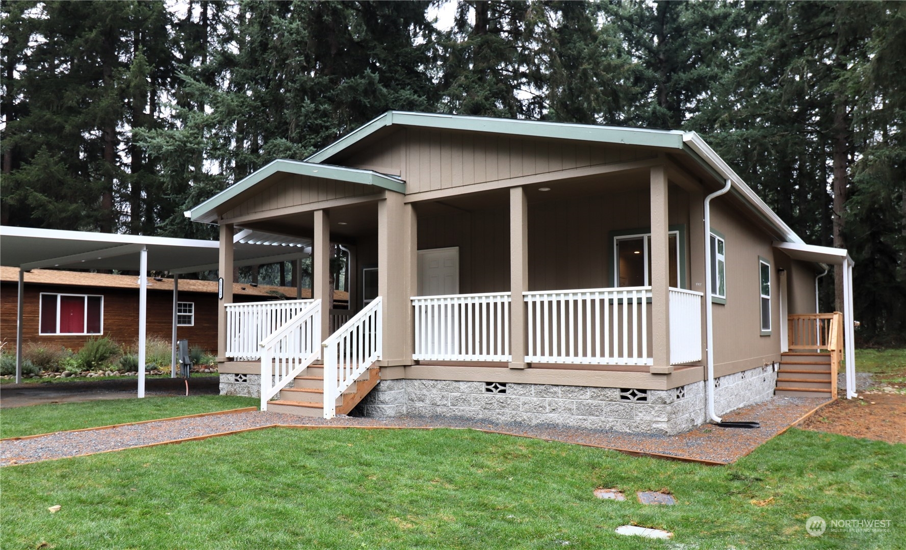 a view of a house with a yard and deck