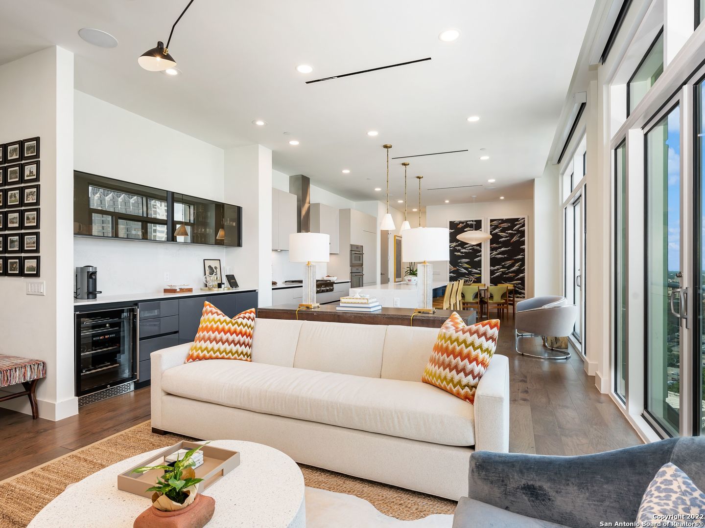 a living room with furniture and a wooden floor