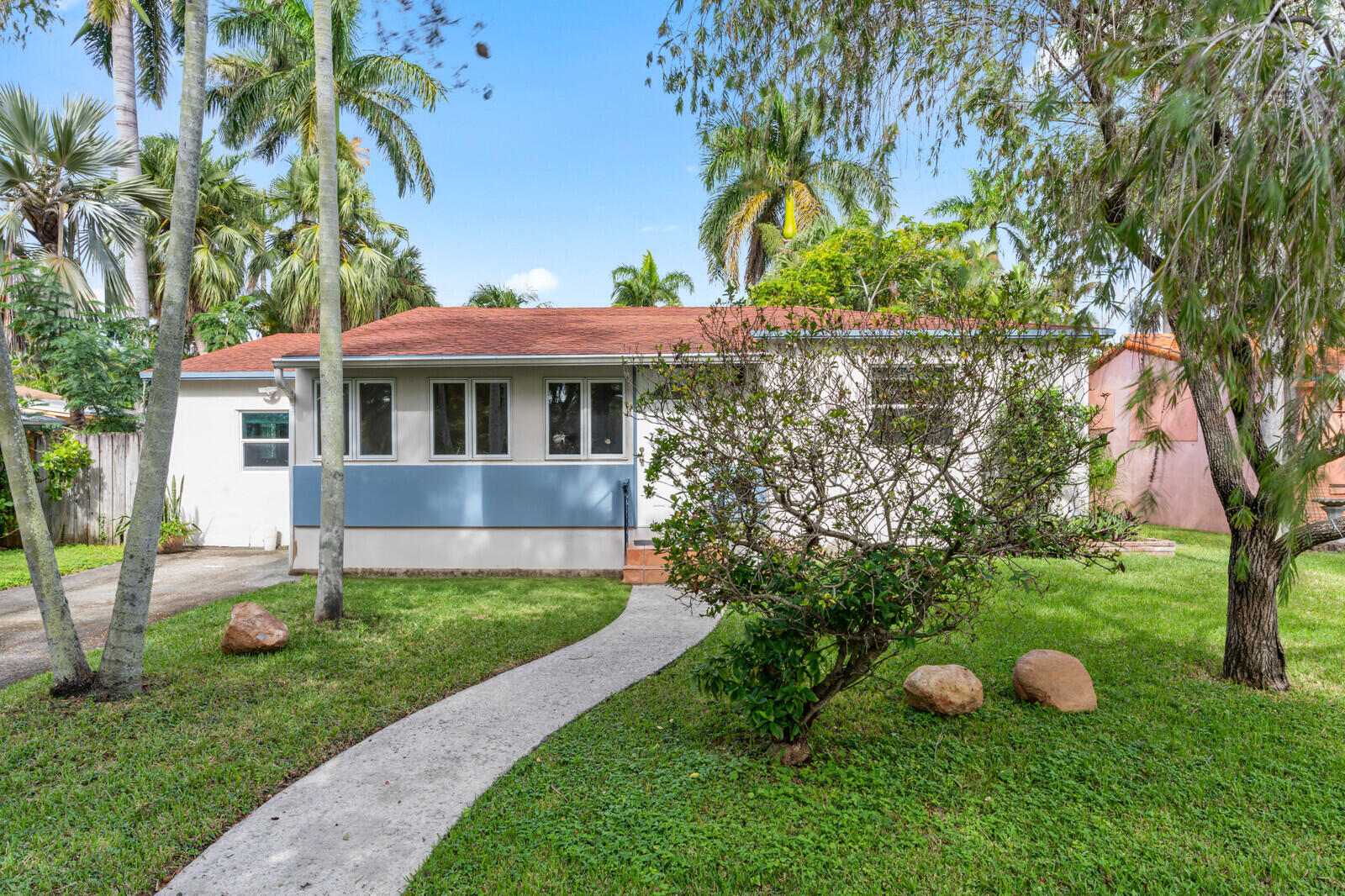 a view of a house with a yard and tree s