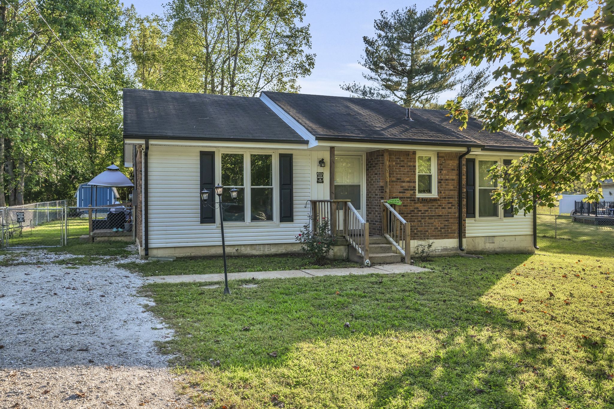 a view of a house with backyard porch and sitting area