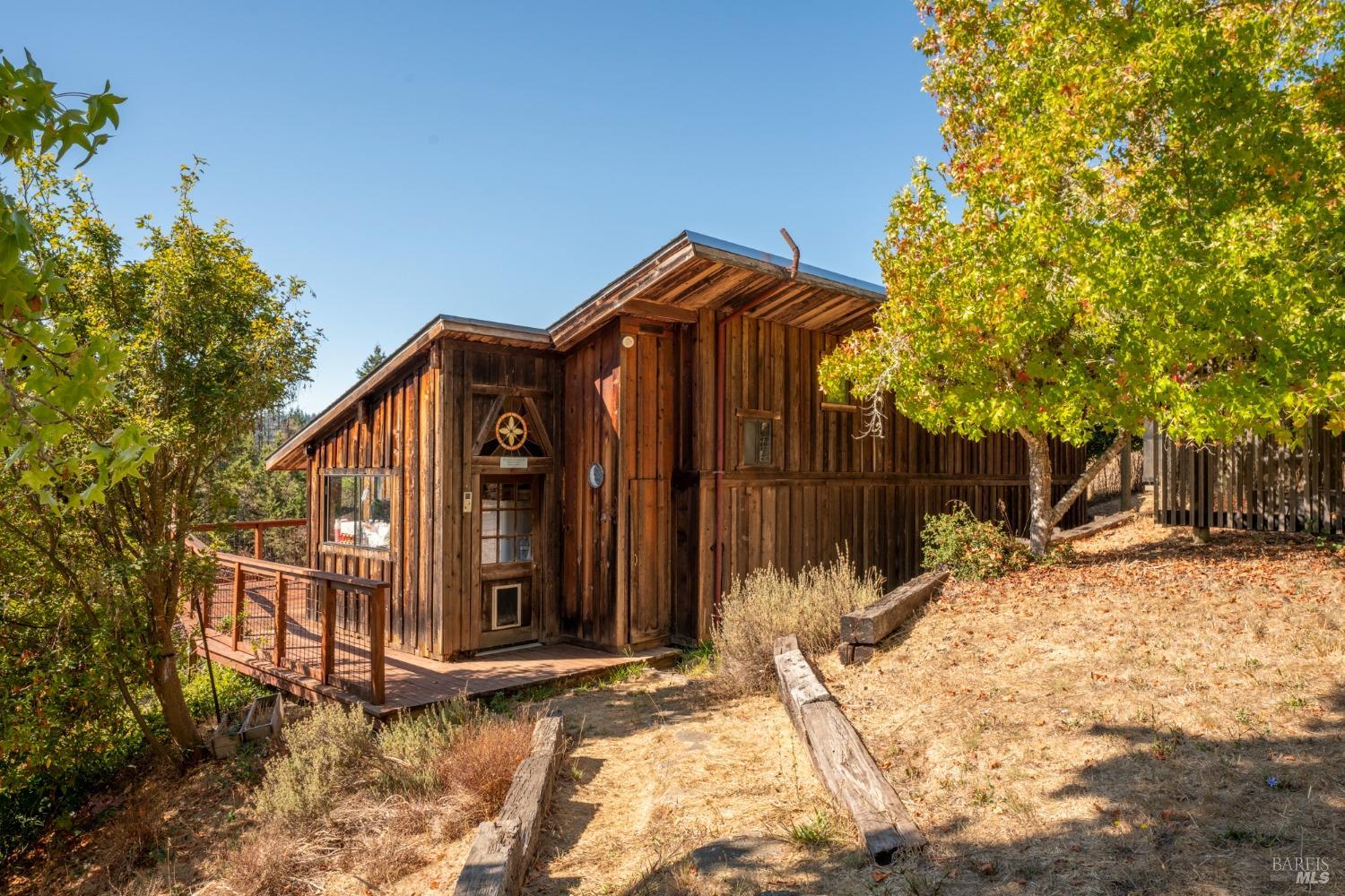 a view of a wooden house with a large trees