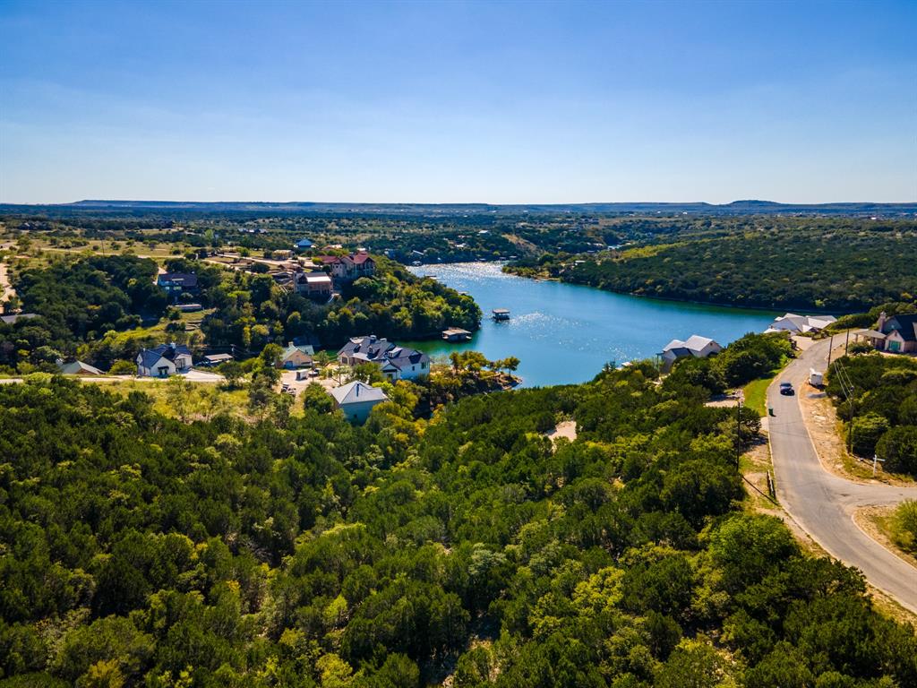 an aerial view of house with yard and lake