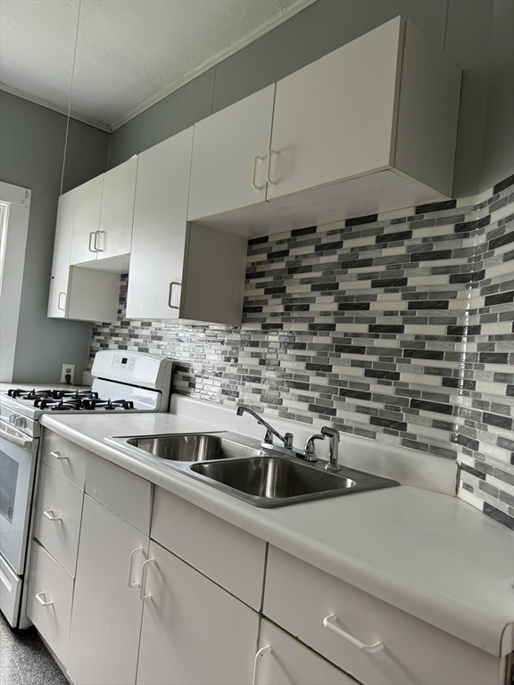 a kitchen with a sink and cabinets