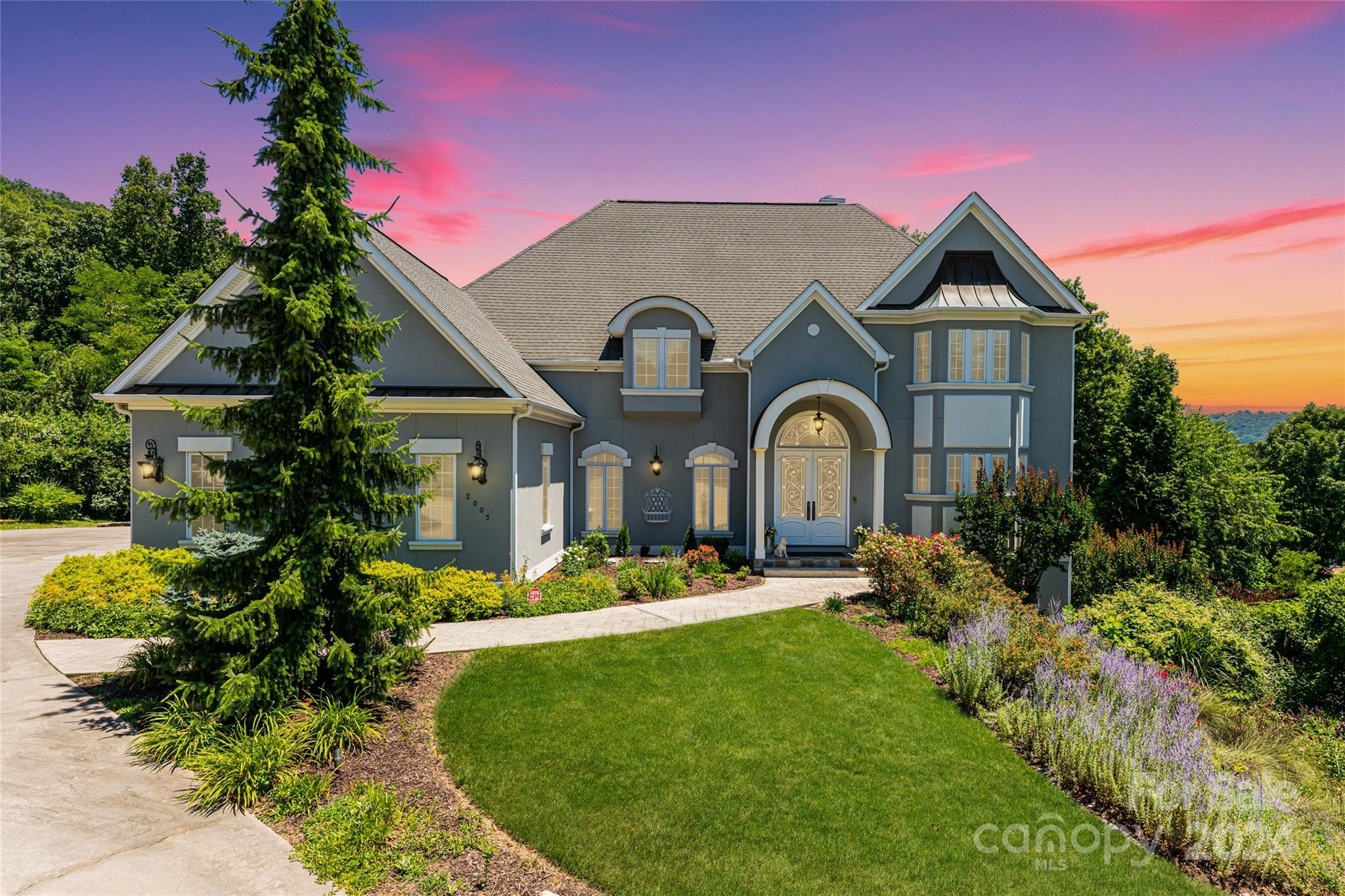 a front view of a house with a garden