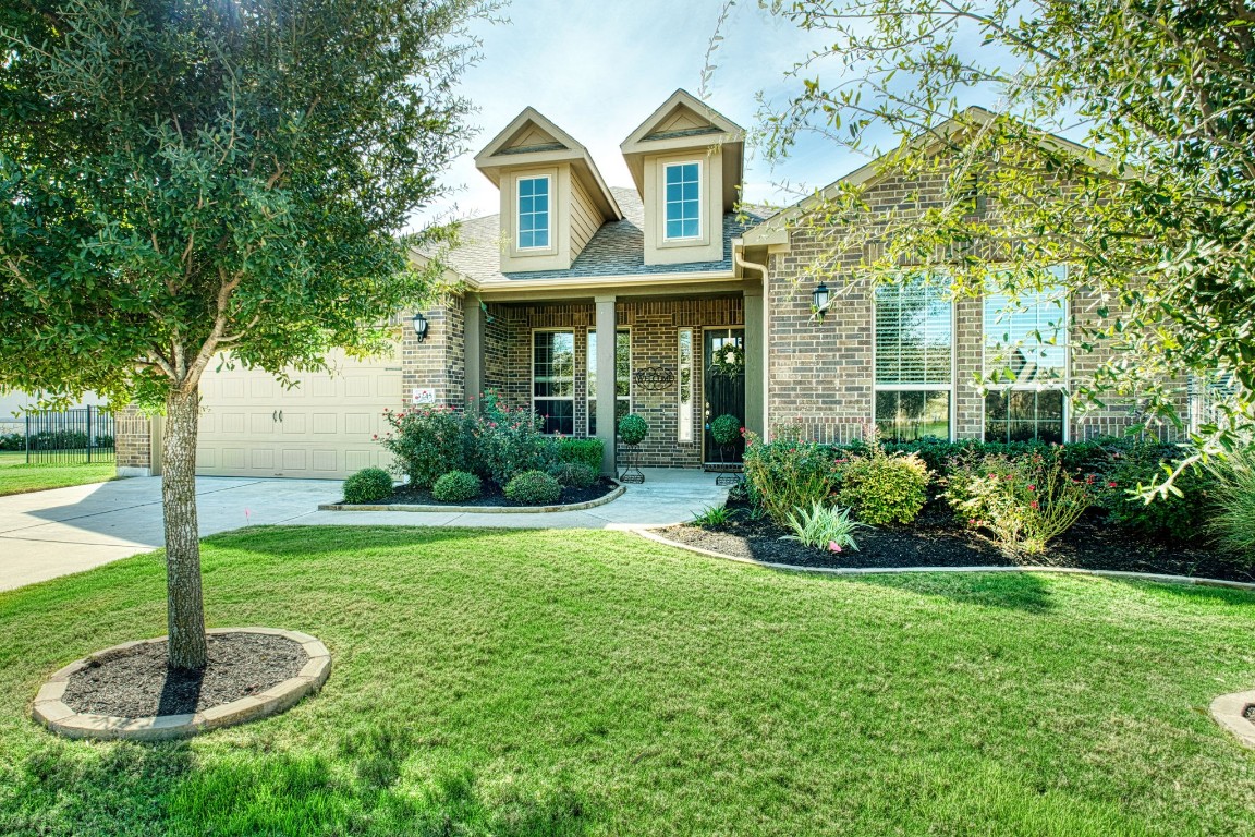 a front view of a house with garden