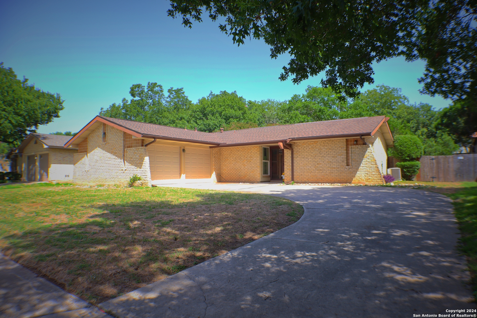 a view of a house with yard and a garage