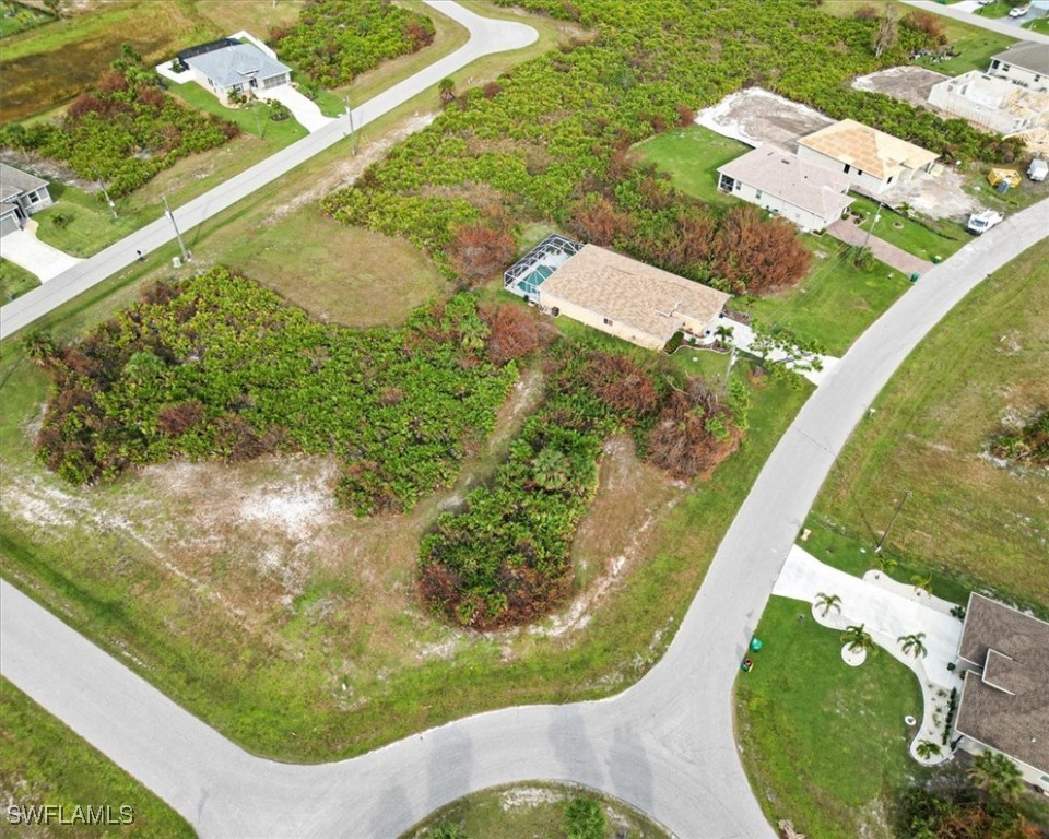 an aerial view of a residential houses with outdoor space