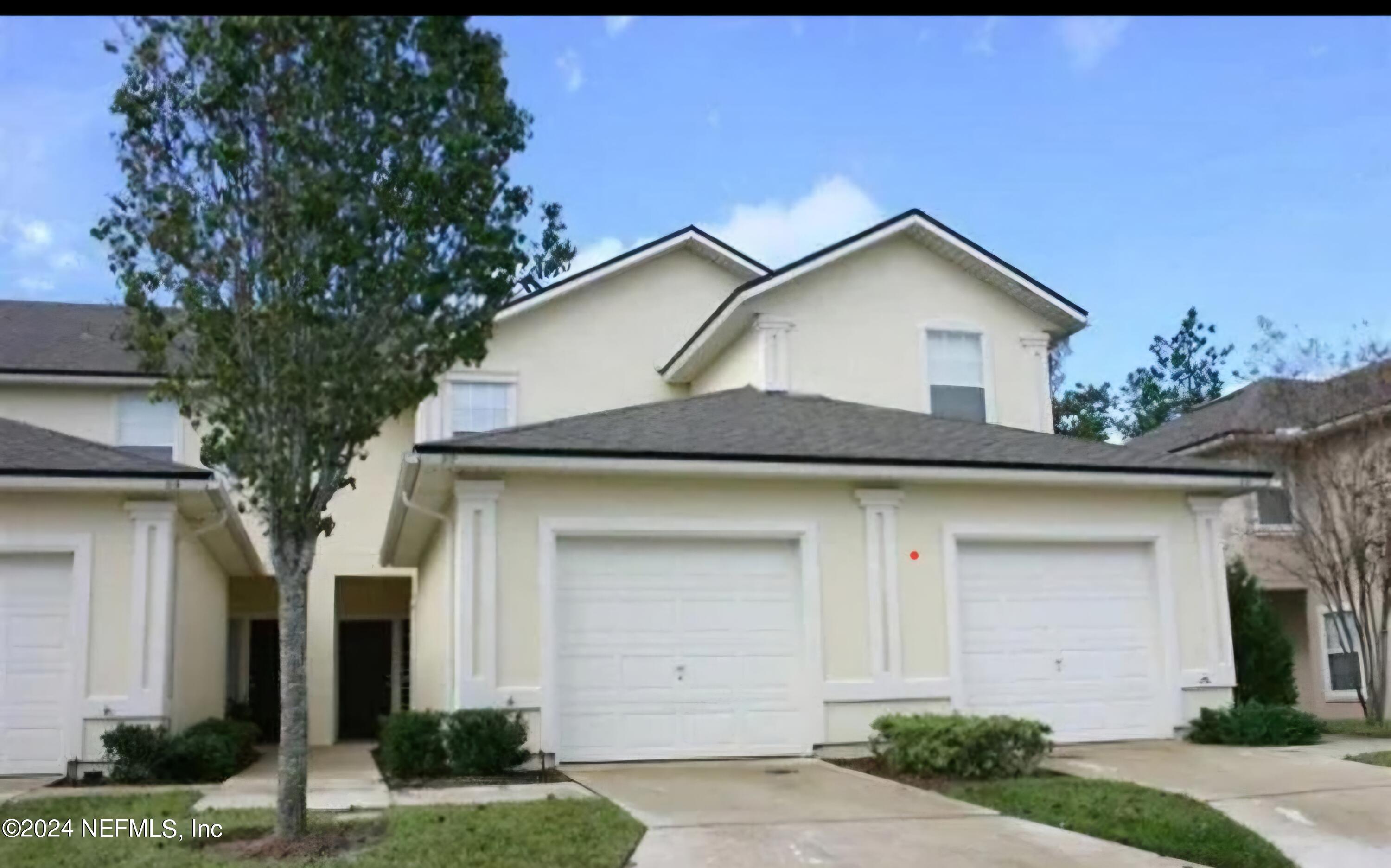 a front view of a house with garage