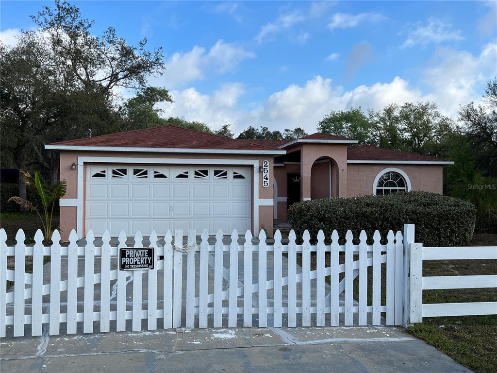 a view of a house with wooden fence