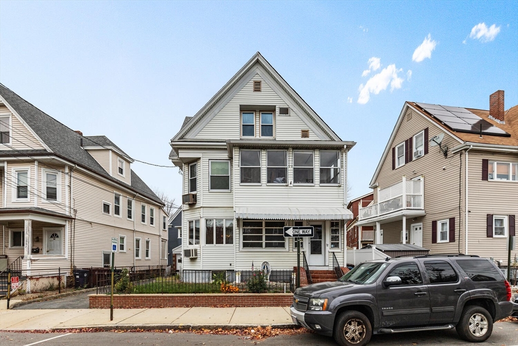 a front view of a residential apartment building with a yard