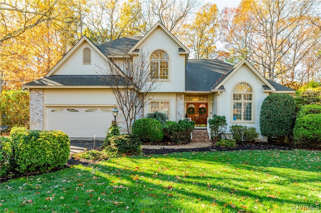 a front view of a house with a yard and garage