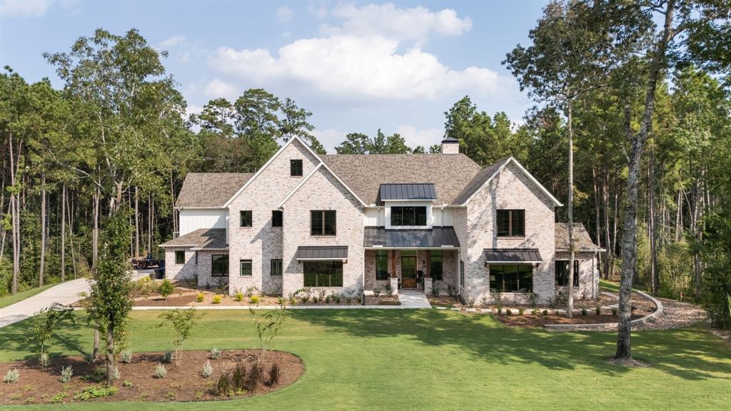 a front view of a house with a garden and swimming pool