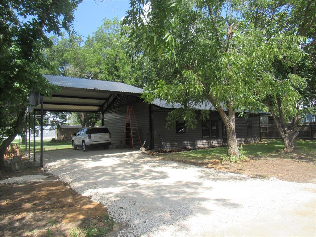 a view of a car park in front of a house