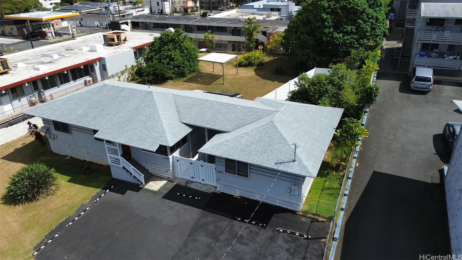 an aerial view of a house with swimming pool and sitting space