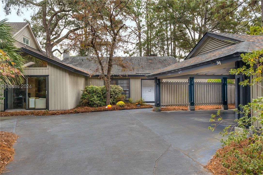 Front elevation with view of the front door and ca