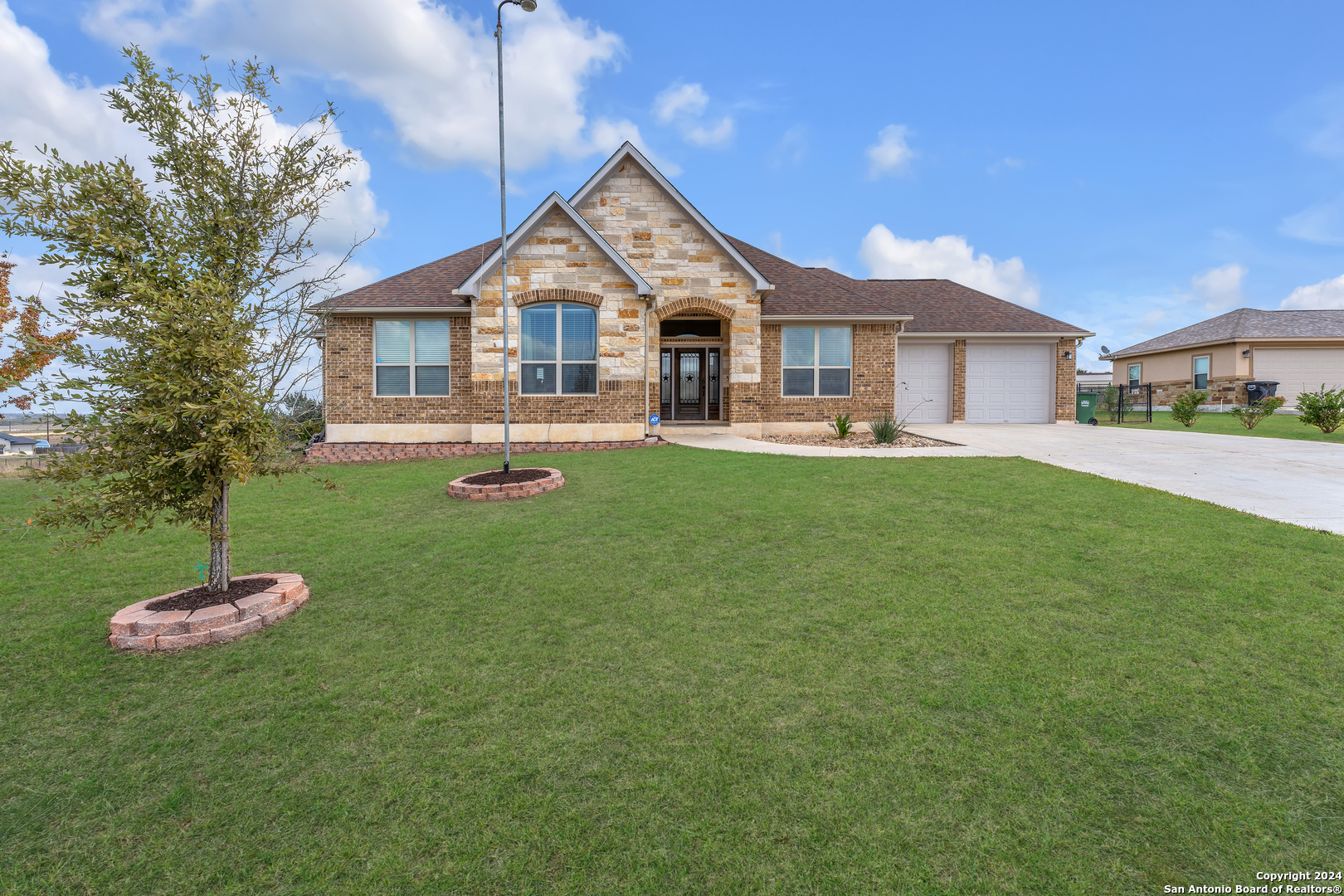 a front view of a house with a yard and porch