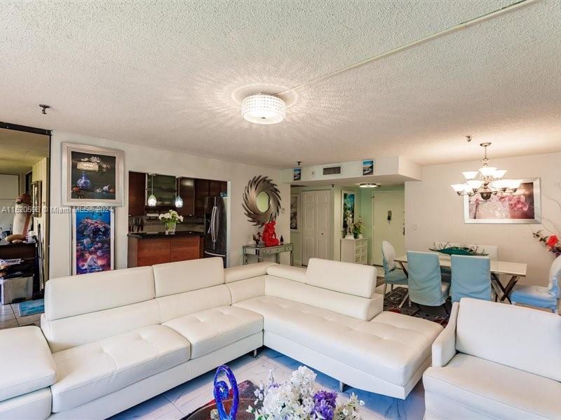 a living room with furniture and a large mirror