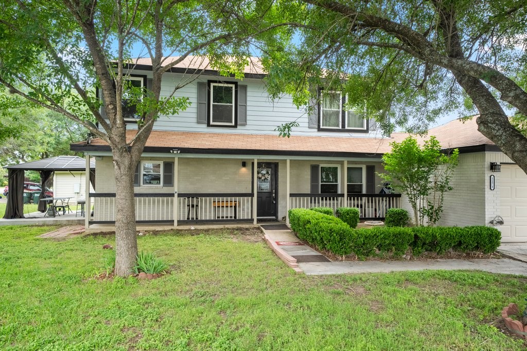 a front view of a house with a yard