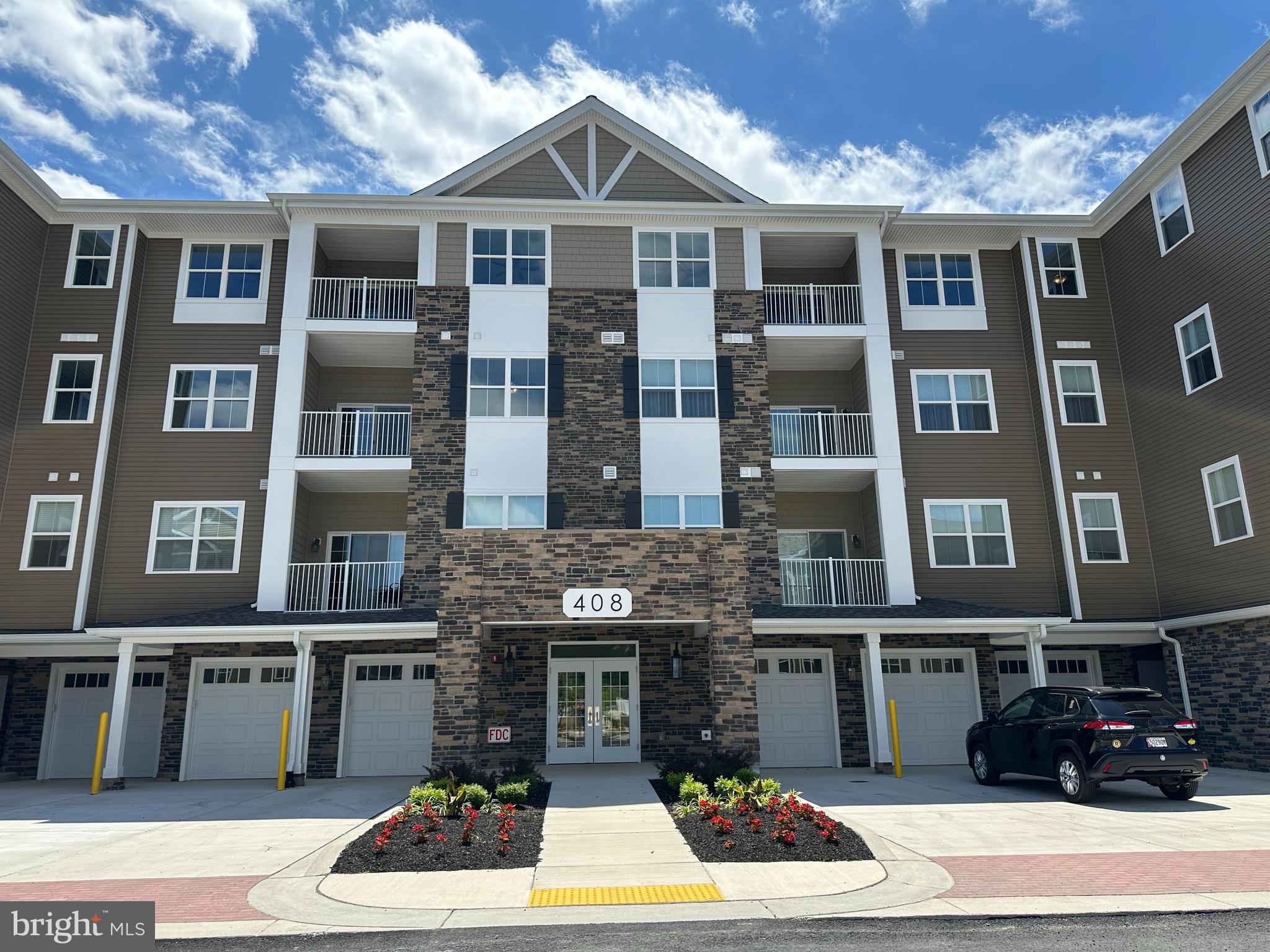 a front view of a residential apartment building with a yard