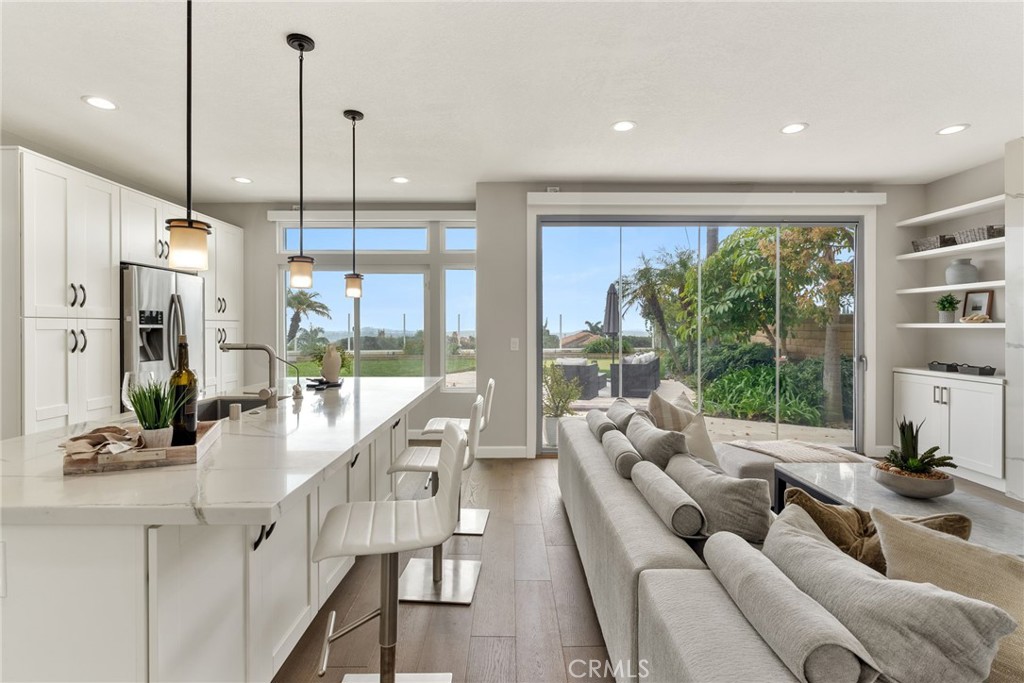 a living room with furniture floor to ceiling window and floor