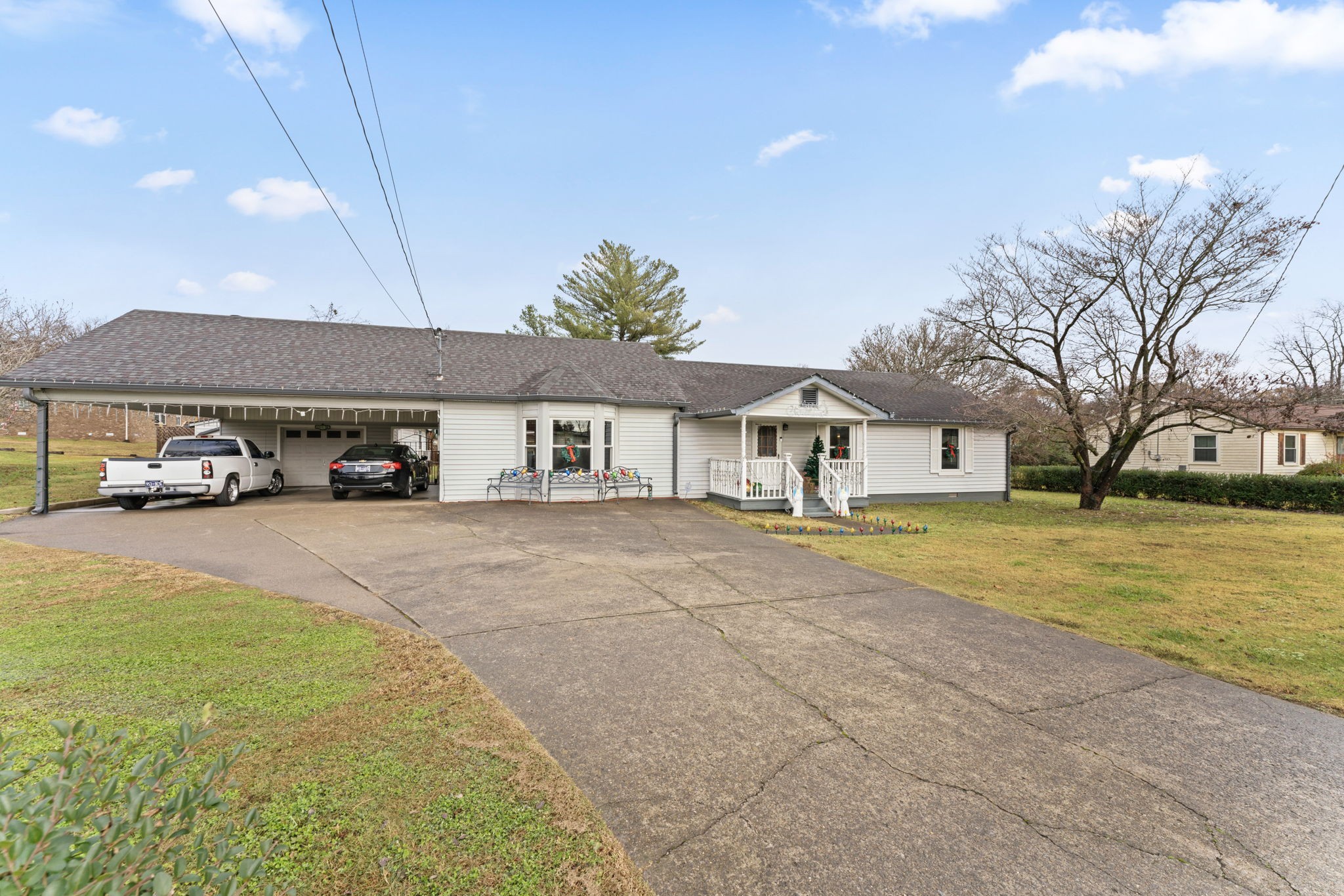 a front view of a house with a yard and a car parked