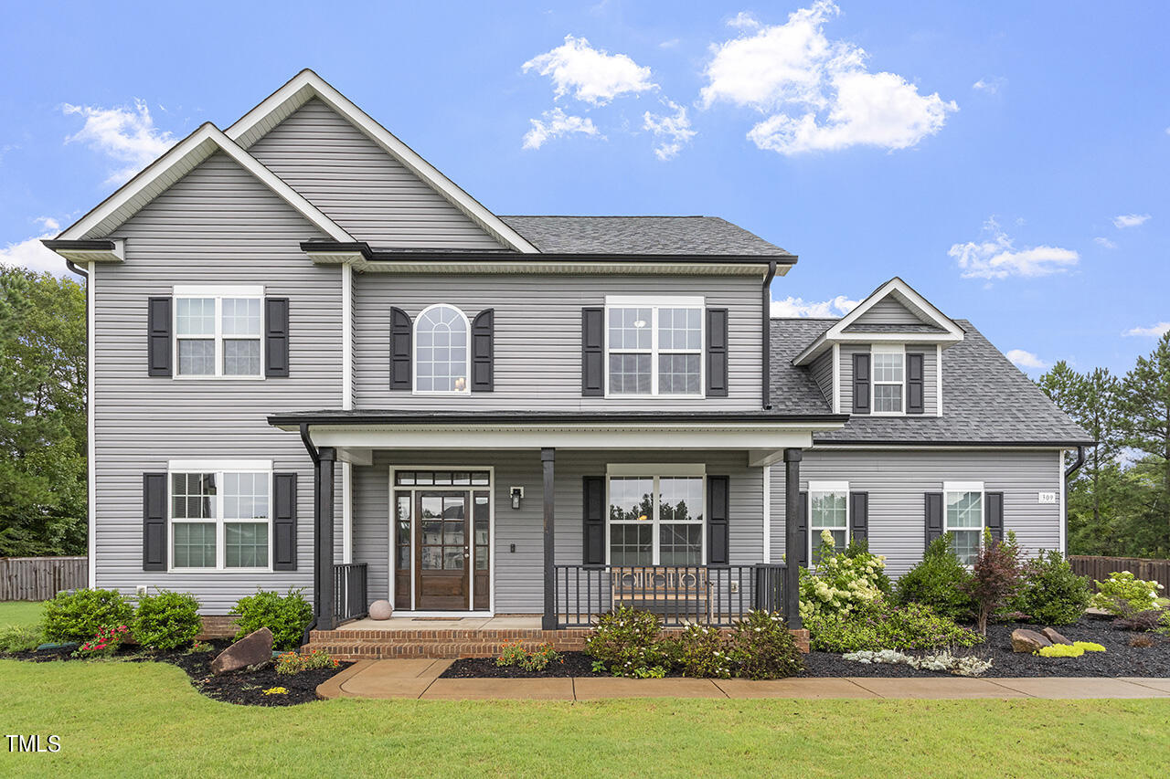 a front view of a house with garden