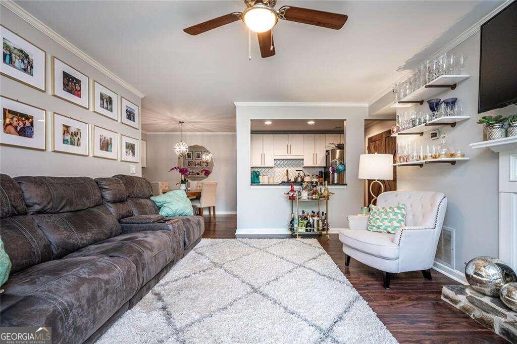 a living room with furniture and a dining room