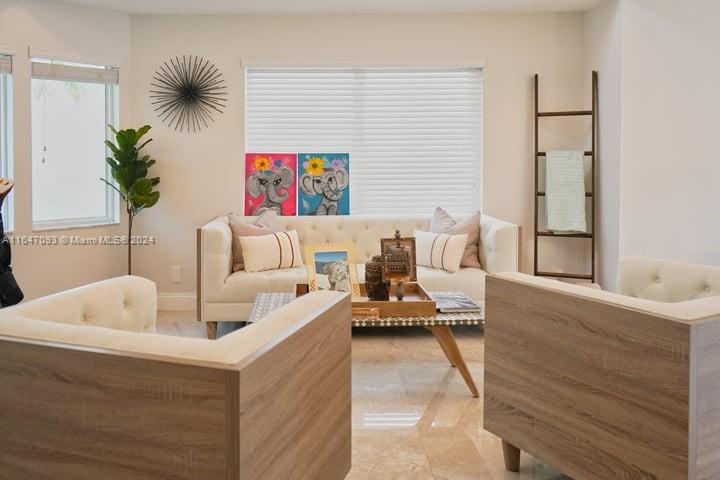 a living room with furniture and a potted plant