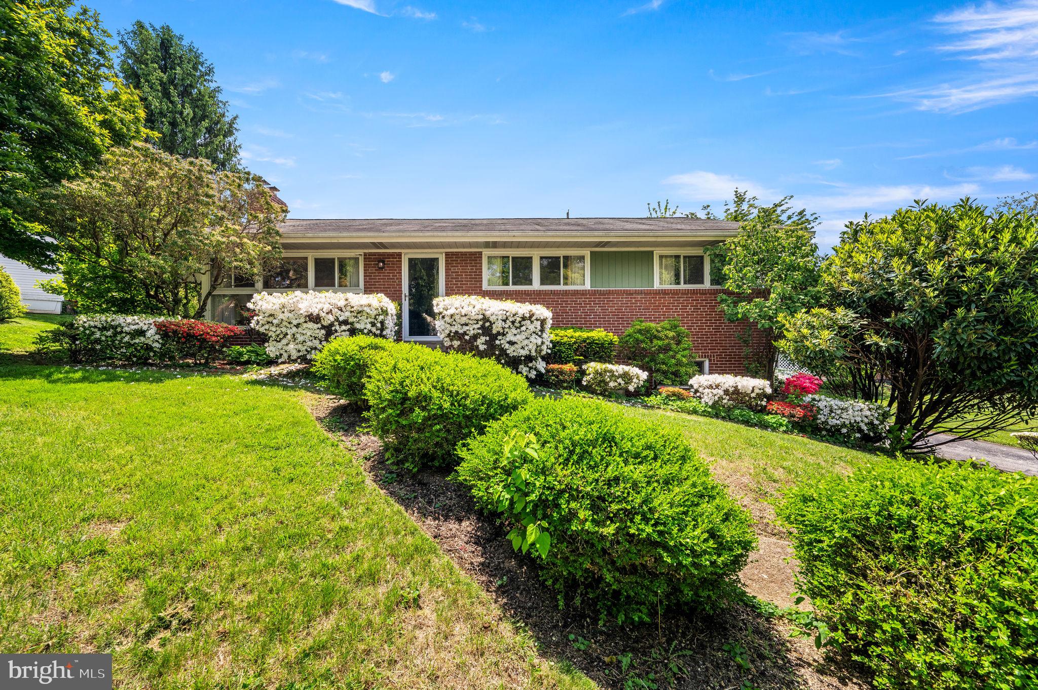 a front view of house with yard and green space