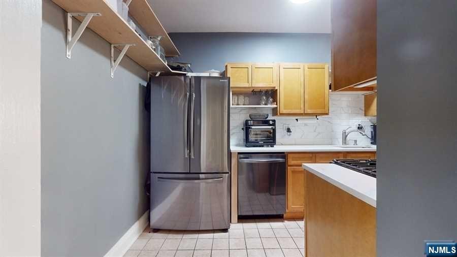 a kitchen with a refrigerator sink and microwave