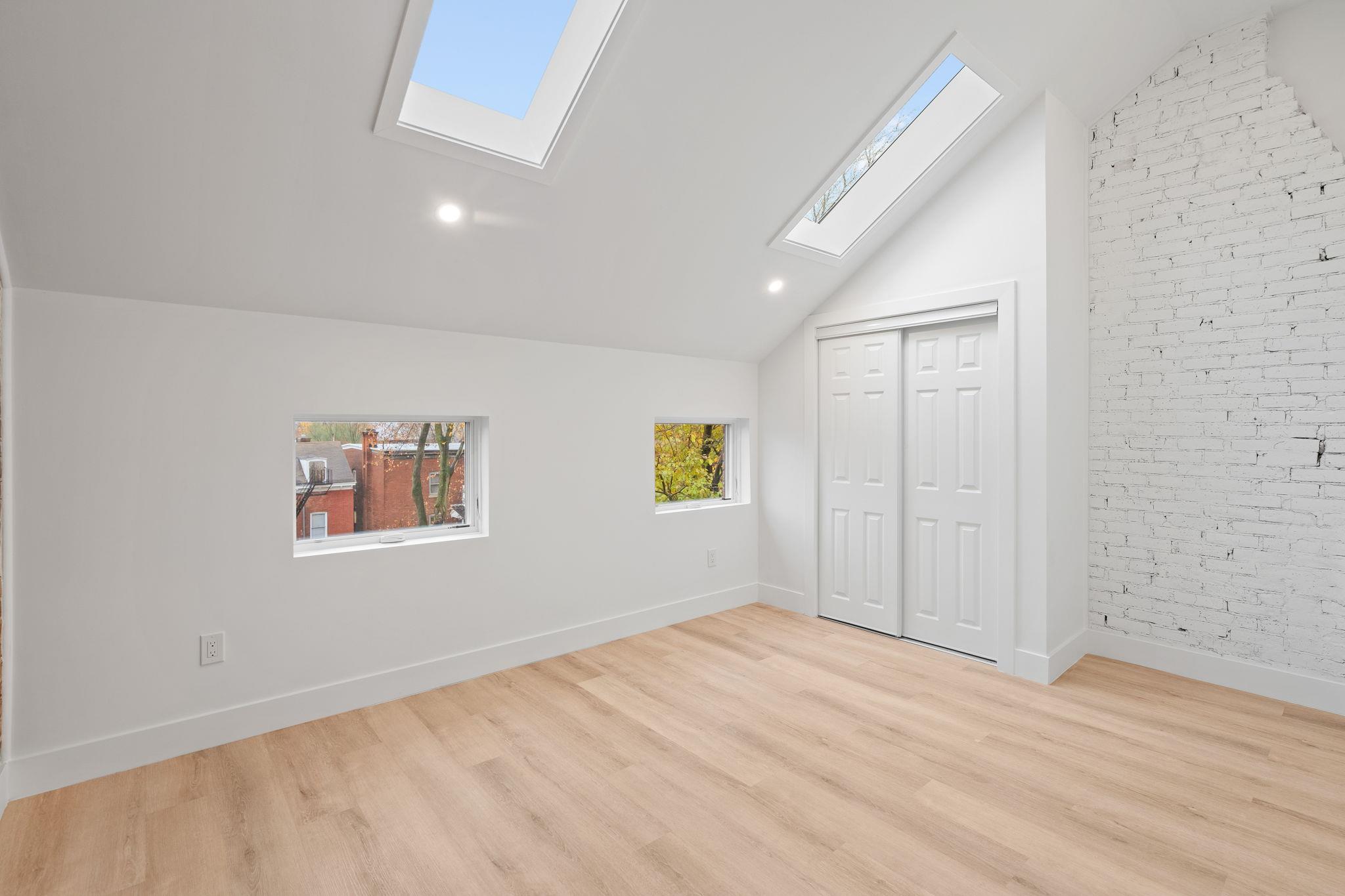 a view of empty room with wooden floor