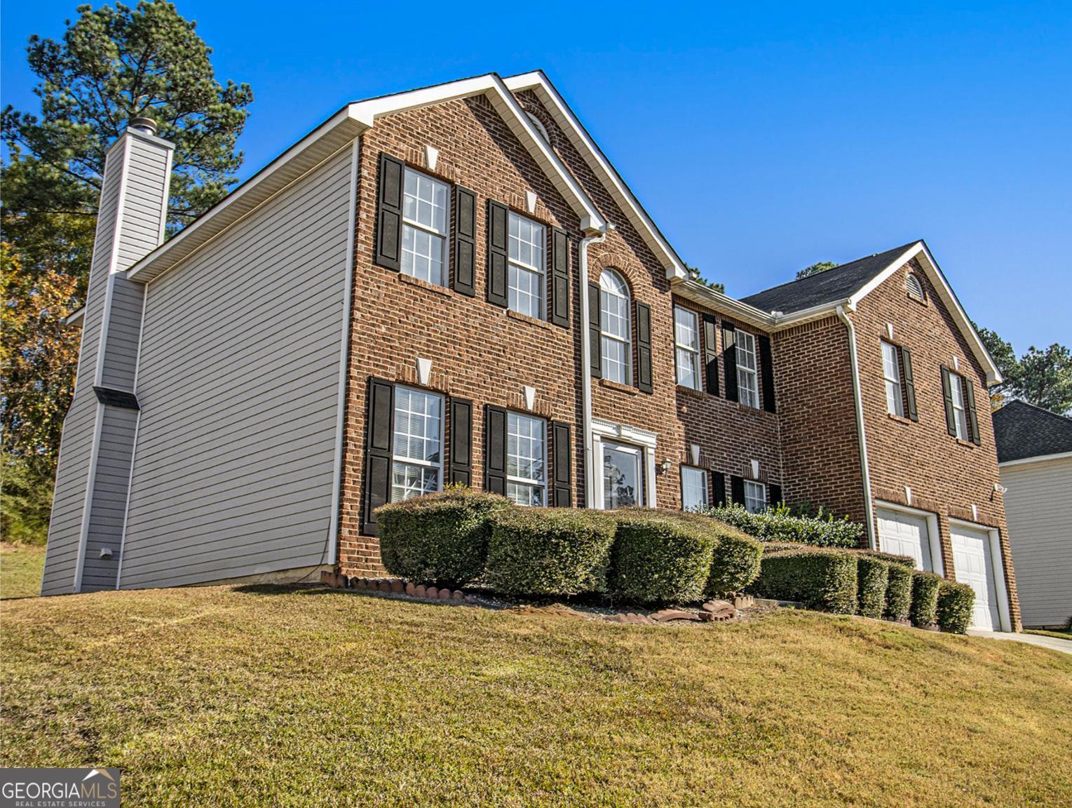 a front view of a house with a yard