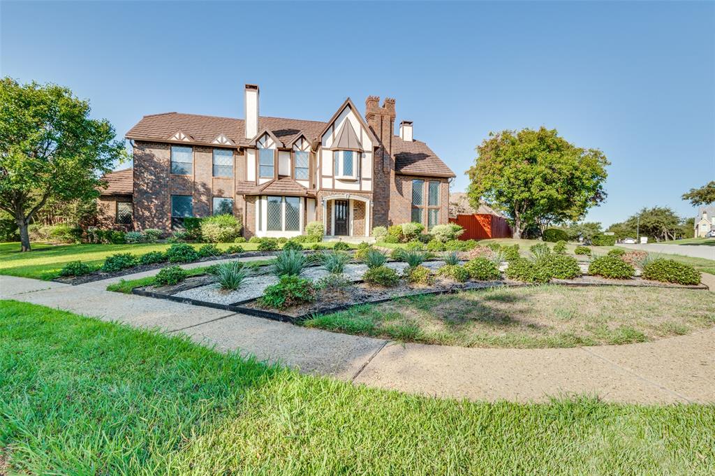 a front view of a house with a garden and porch