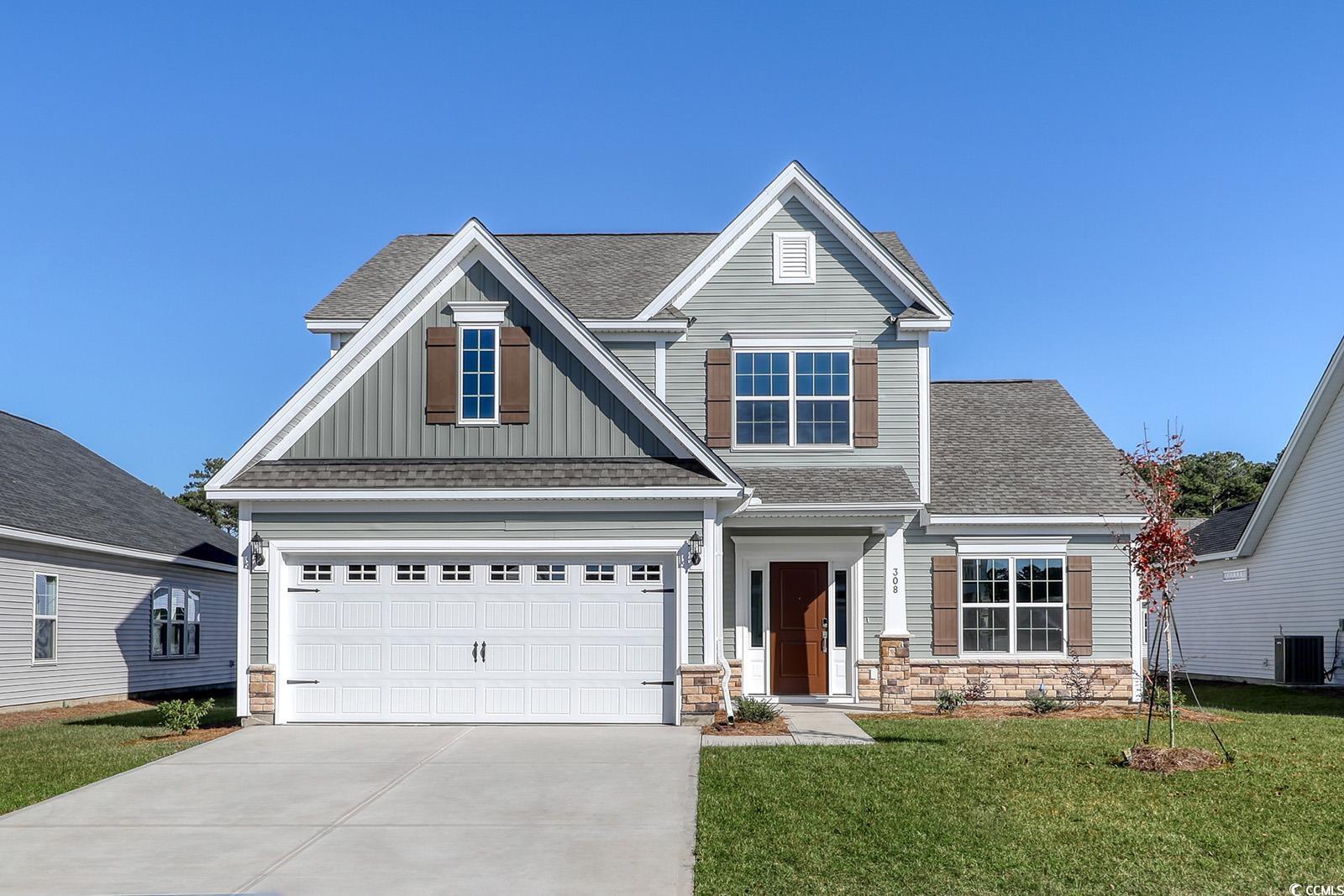 Craftsman inspired home with a garage, a front law