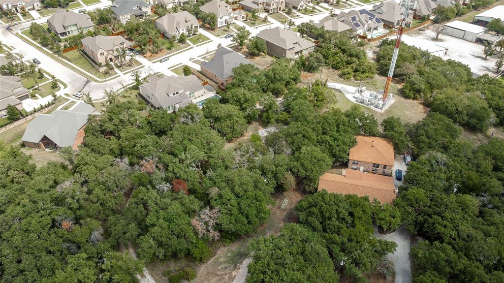 an aerial view of a house with a yard and lake view