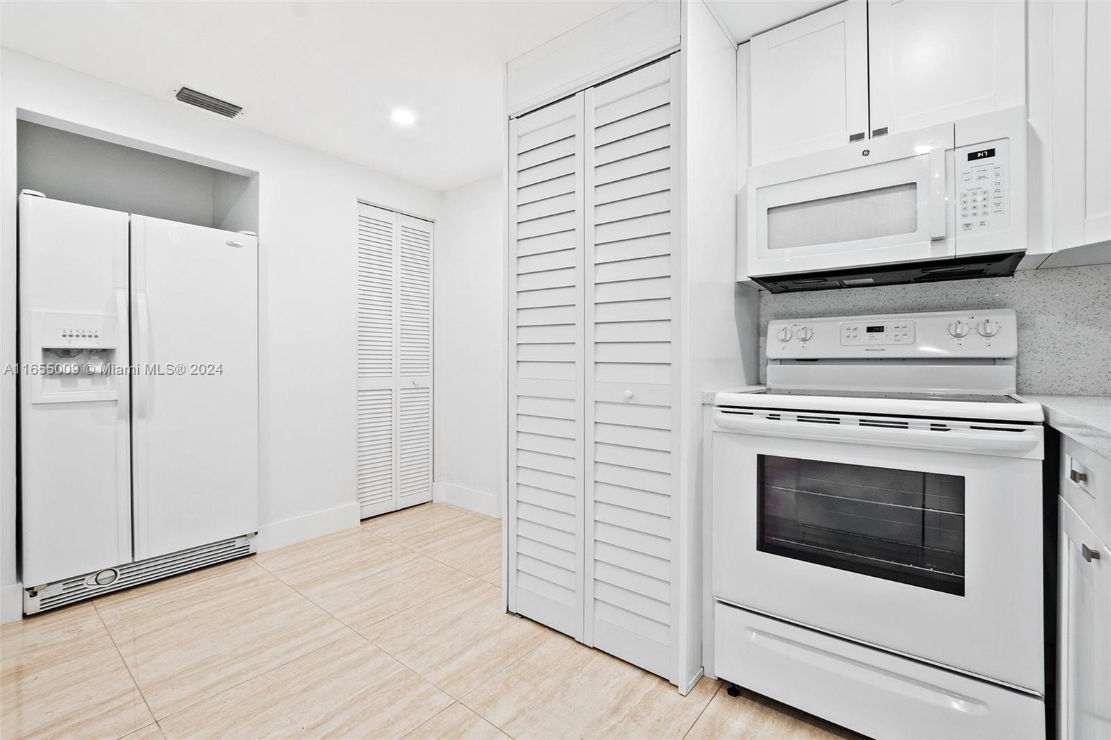 a view of a hallway with washer and dryer