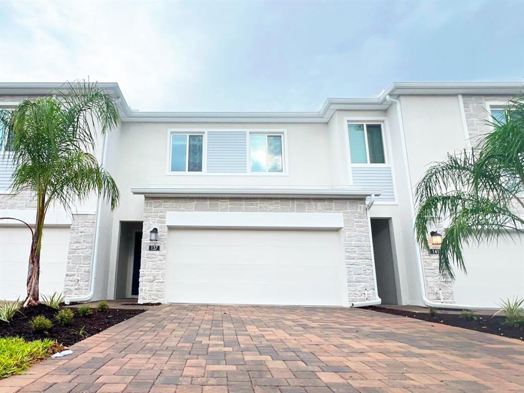 a front view of a house with a yard and garage