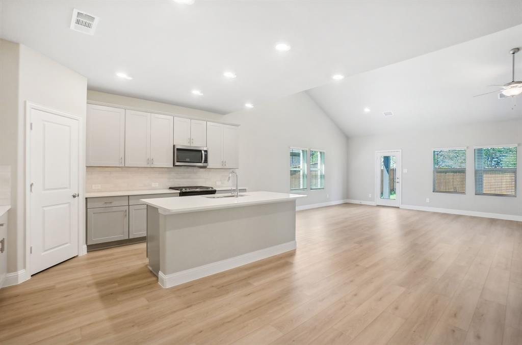 a kitchen with a stove a sink and a refrigerator