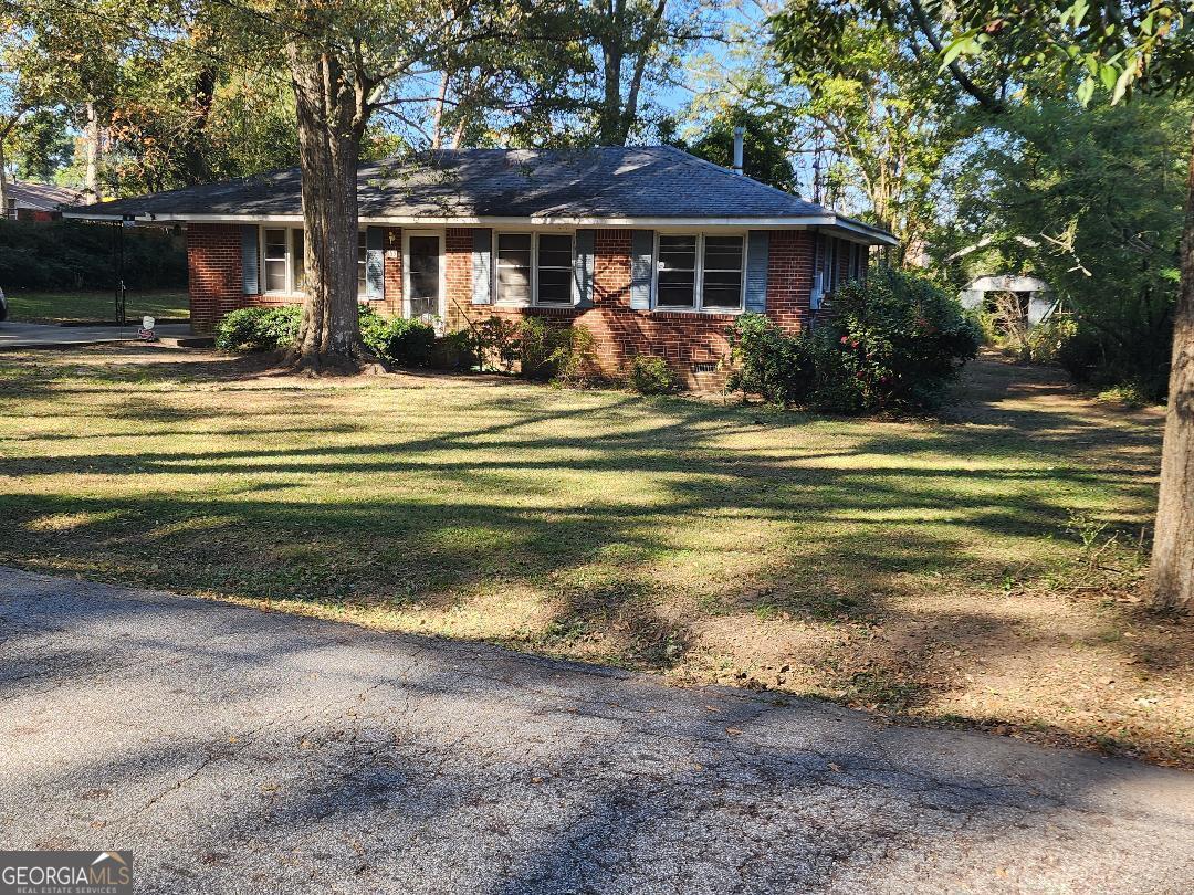 a front view of a house with a yard table and chairs